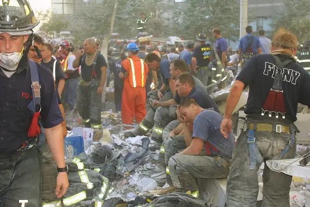 New York City firefighters rest during rescue operations at the World Trade Center